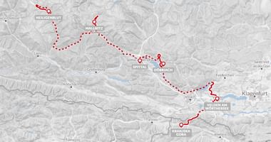 Kaart met fietsroute door de Oostenrijkse Alpen met rode stippellijn via Heiligenblut, Spittal, Villach en Klagenfurt.