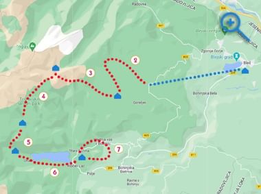 Huttentocht kaart Julische Alpen Topografische kaart met genummerde wandelroute door Julische Alpen met rood-blauwe stippellijnen tussen hutten, Meer van Bled zichtbaar.