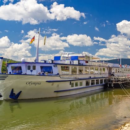 MS Olmpia at a pier on the Rhine River