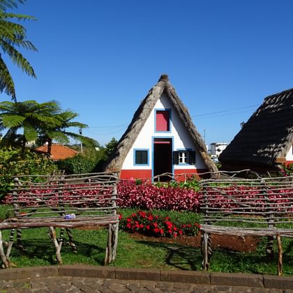 Wooden benches in front of colourful huts
