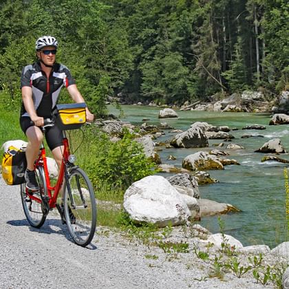 Cyclist riding along a river