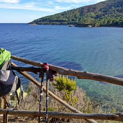 Backpack on railing with sea in the background on Elba